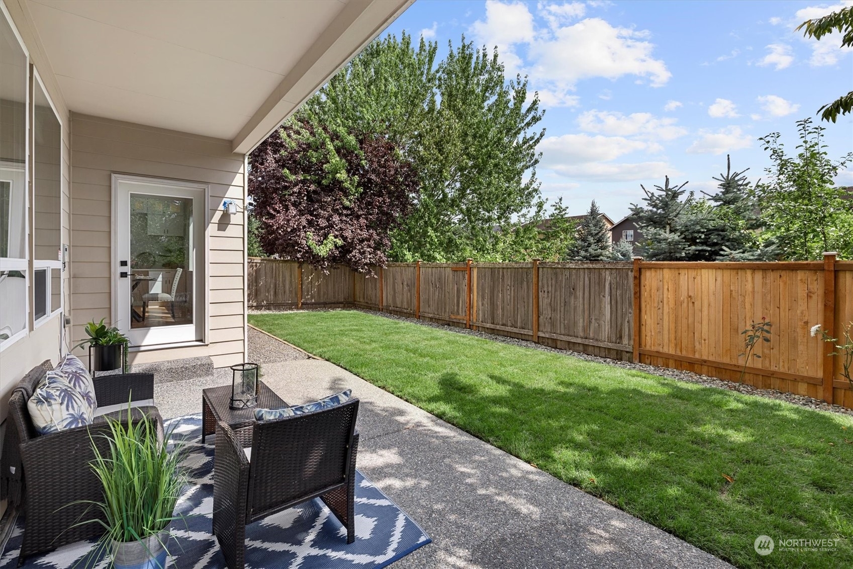 3622 222nd Place Southeast Bothell, WA 98021 - Photo 21 of 40 a view of a backyard with table and chairs potted plants and wooden fence