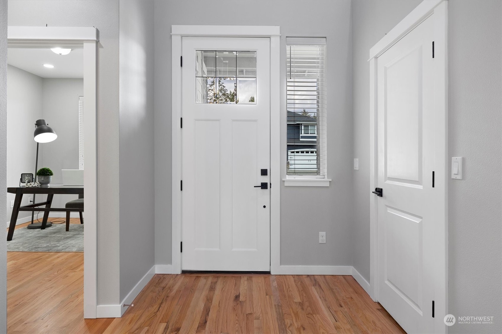 3622 222nd Place Southeast Bothell, WA 98021 - Photo 3 of 40 a view of a hallway with wooden floor and dining room