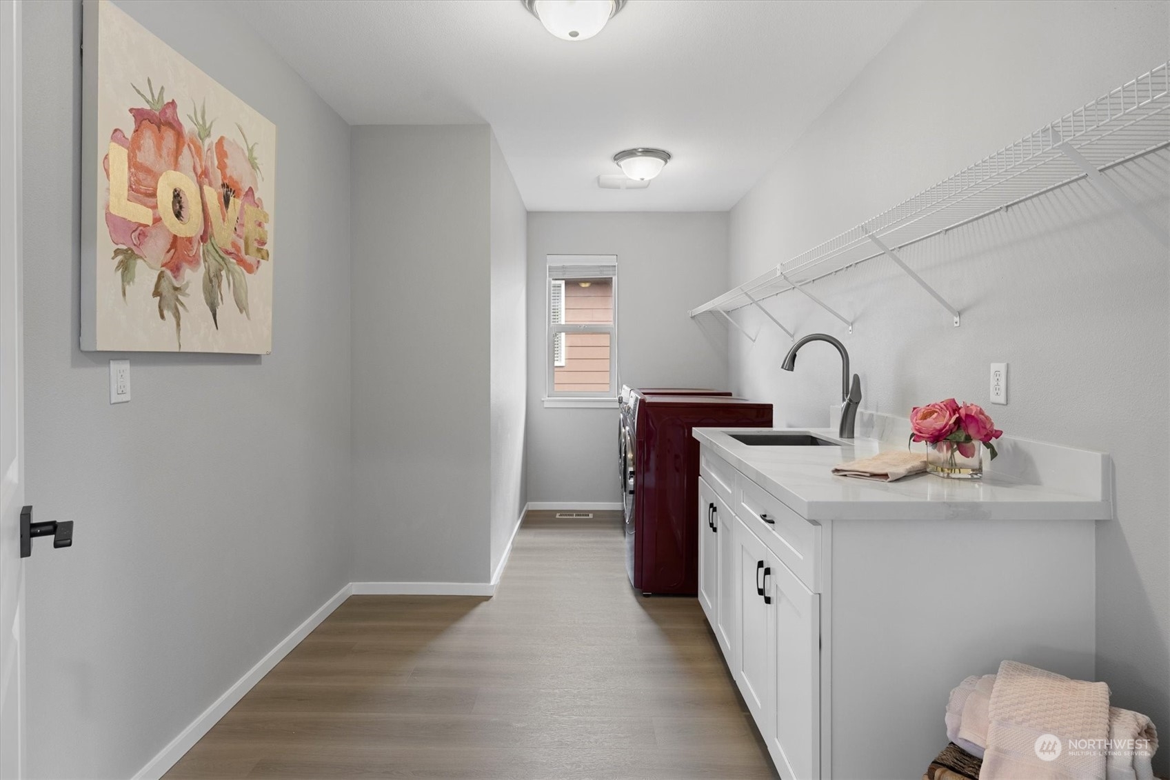 3622 222nd Place Southeast Bothell, WA 98021 - Photo 37 of 40 a hall with a sink cabinets and wooden floor