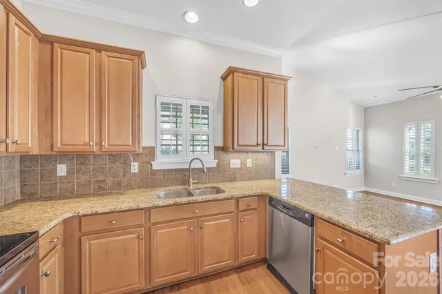 a kitchen with granite countertop cabinets sink and window