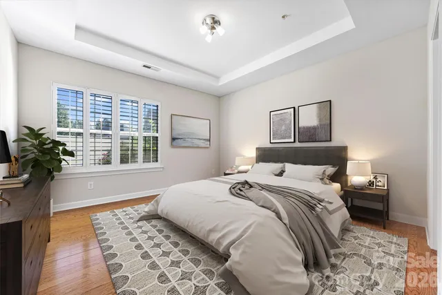 a bedroom with a large bed plant and a window