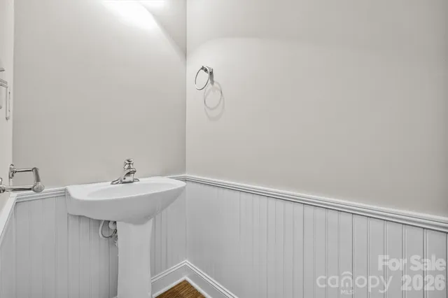 a bathroom with a sink a mirror and shower curtain