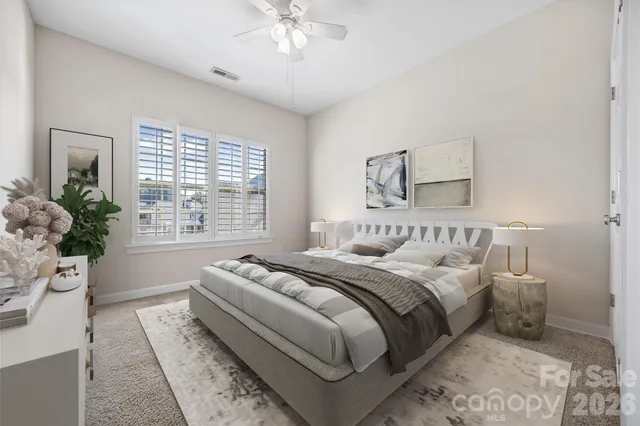 a bedroom with a large bed and a window