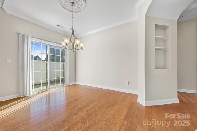 a view of a room with wooden floor and entryway