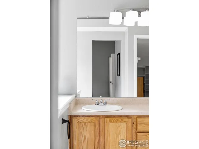 a bedroom with a bed and a wall painting