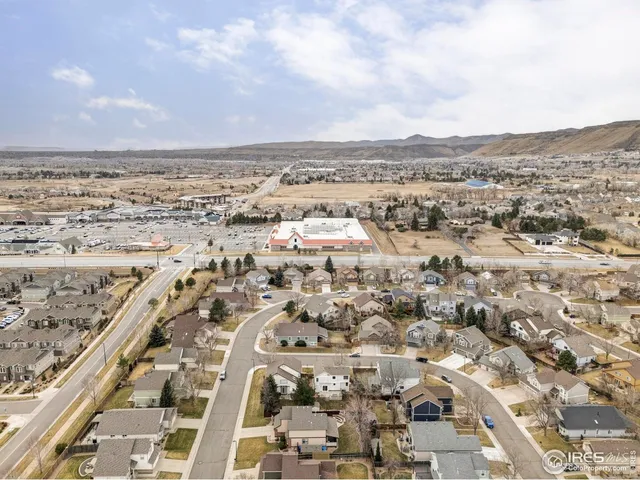 an aerial view of a house with a yard