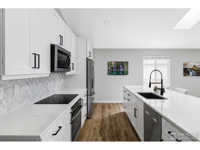 a kitchen with sink stove and cabinets
