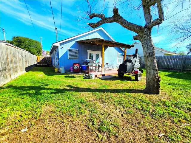 a view of an house with backyard space and porch