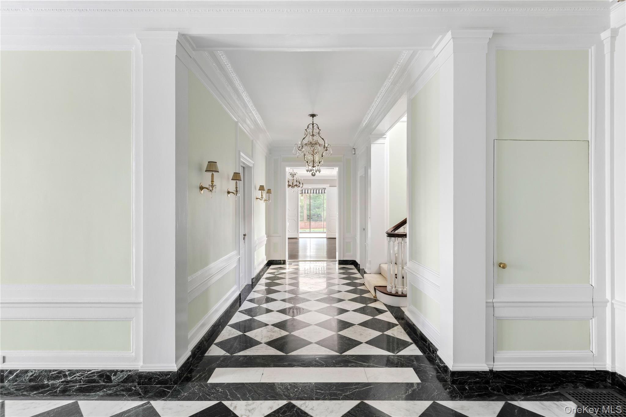 393 Mill River Road Muttontown, NY 11771 - Photo 12 of 41 a view of a hallway with wooden floor and a living room