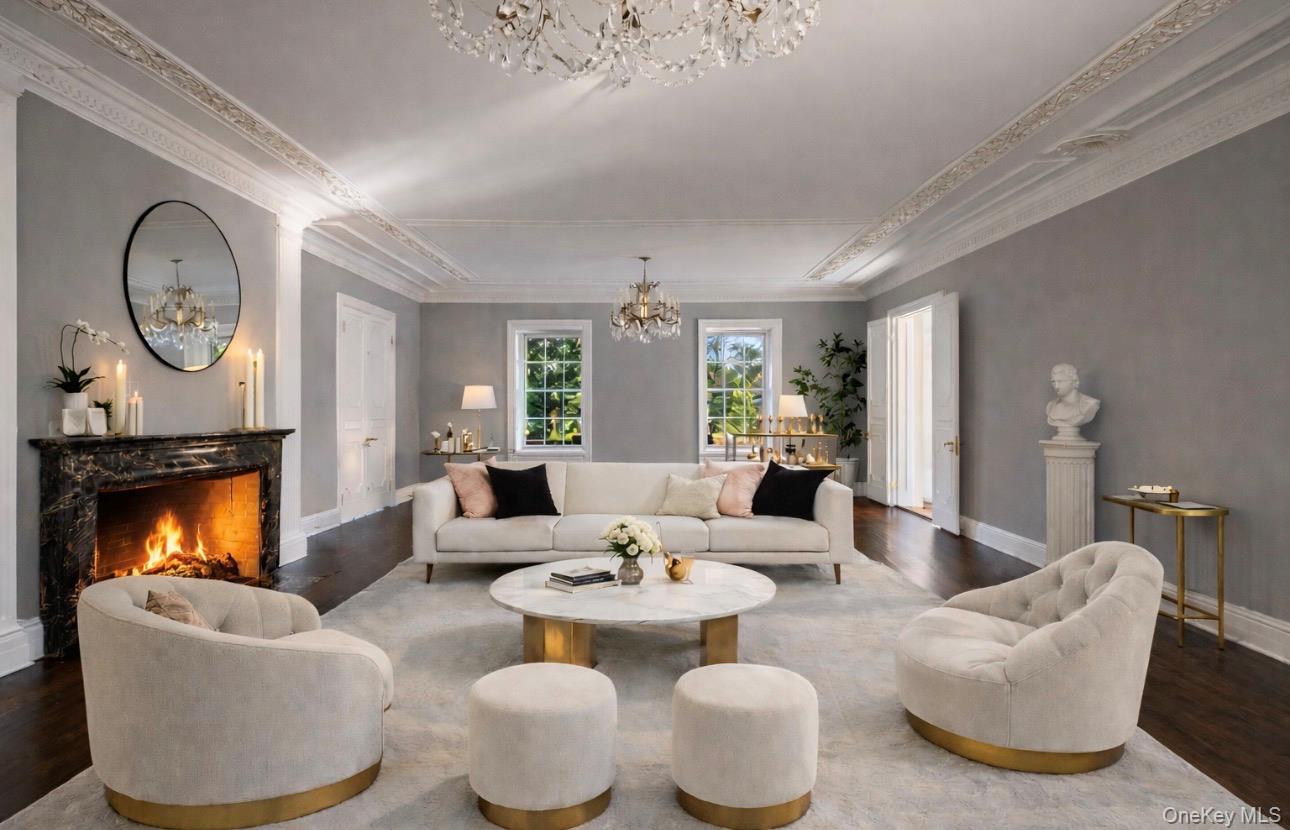 393 Mill River Road Muttontown, NY 11771 - Photo 13 of 41 a living room with furniture chandelier and fireplace