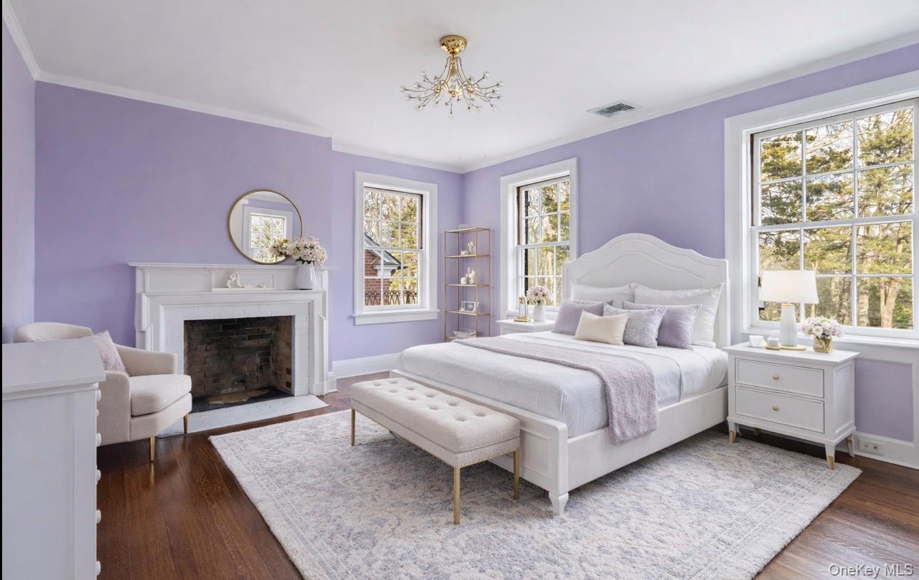 393 Mill River Road Muttontown, NY 11771 - Photo 20 of 41 a spacious bedroom with a bed and a fireplace