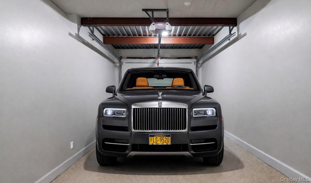 393 Mill River Road Muttontown, NY 11771 - Photo 34 of 41 a car parked in a garage