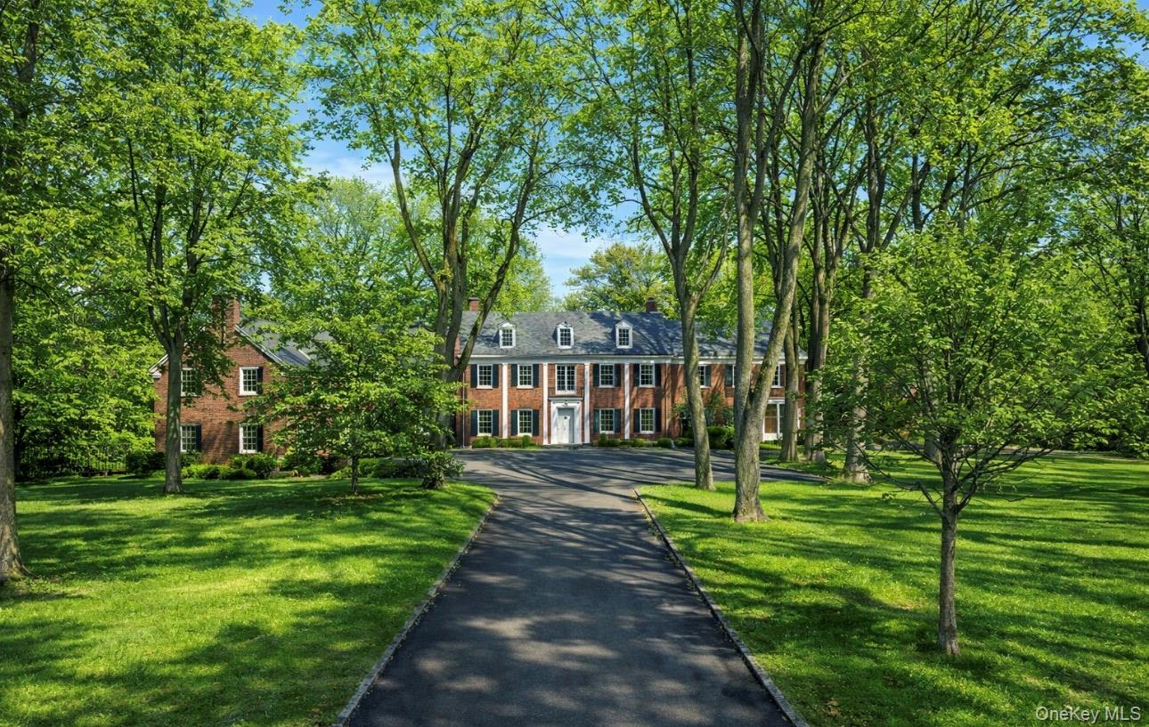 393 Mill River Road Muttontown, NY 11771 - Photo 39 of 41 a front view of a house with a yard