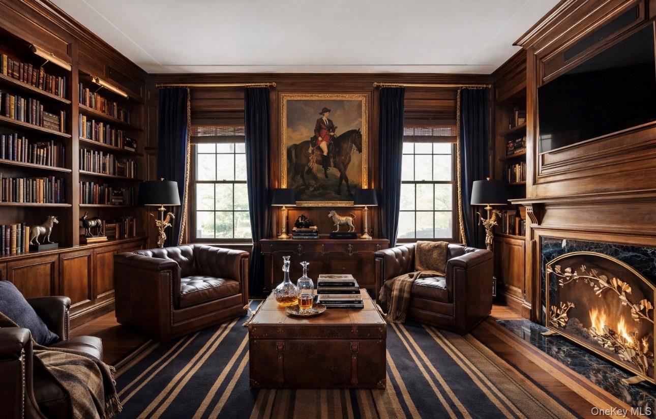 393 Mill River Road Muttontown, NY 11771 - Photo 6 of 41 a living room with furniture or couch and a fireplace