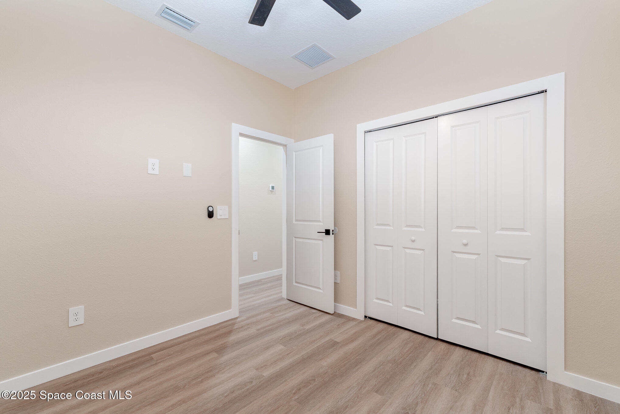 15615 Southwest 49th Avenue Road Ocala, FL 34473 - Photo 9 of 23 a view of an empty room with a fan and a window