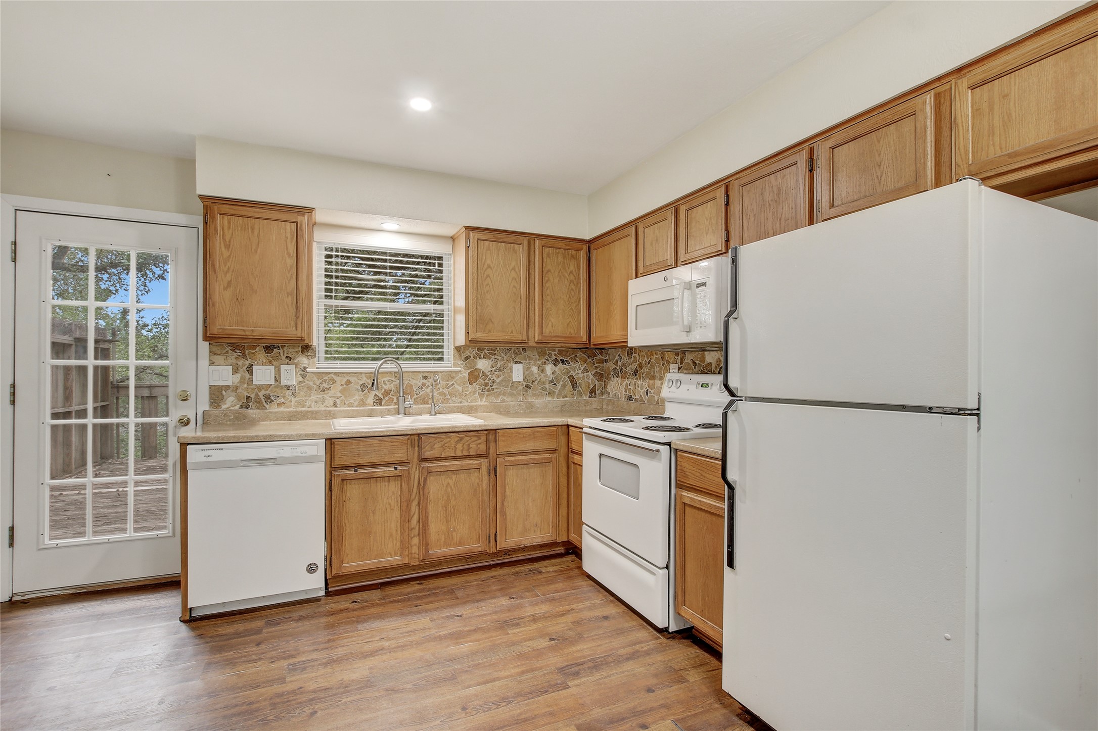 6902 Rifle Bend, Unit B Austin, TX 78736 - Photo 9 of 34 a kitchen with stainless steel appliances a refrigerator sink and microwave