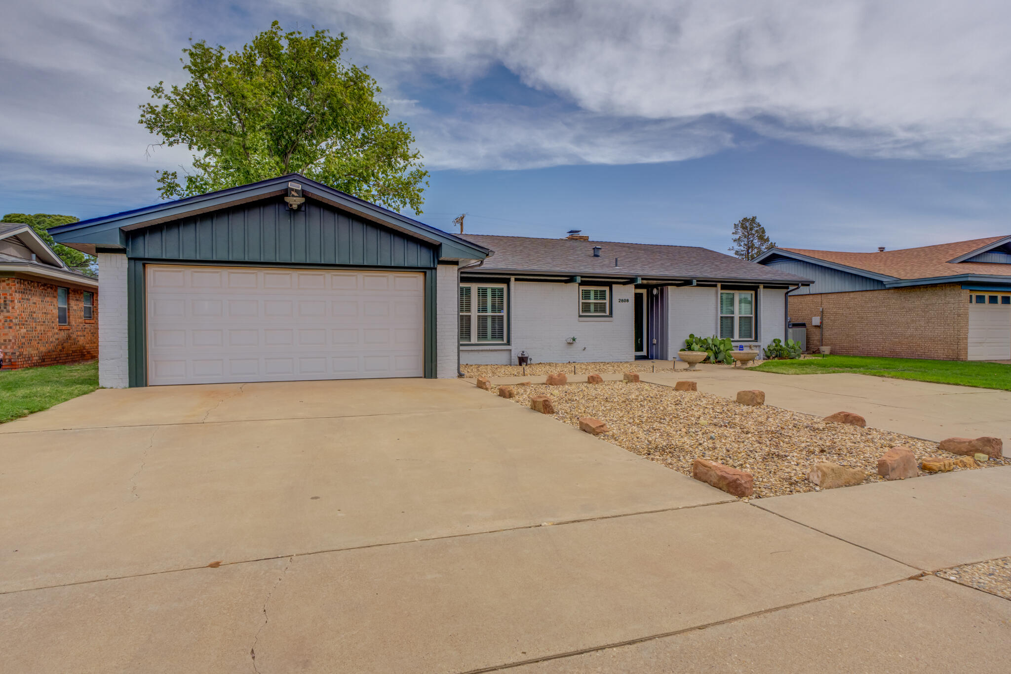 2608 74th Place Lubbock, TX 79423 - Photo 1 of 38 a front view of house with garage and yard