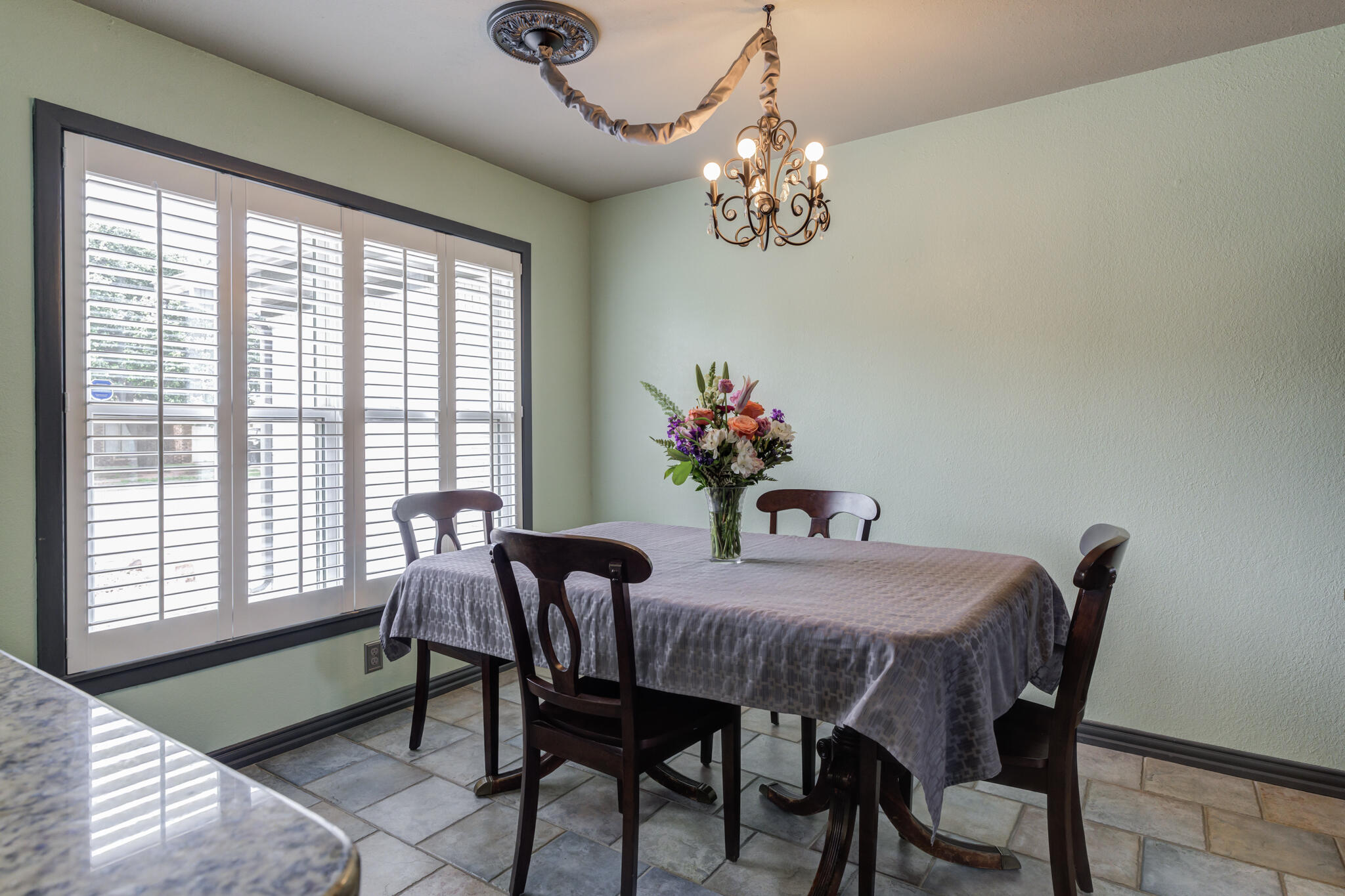2608 74th Place Lubbock, TX 79423 - Photo 13 of 38 a view of a dining room with furniture a chandelier and window