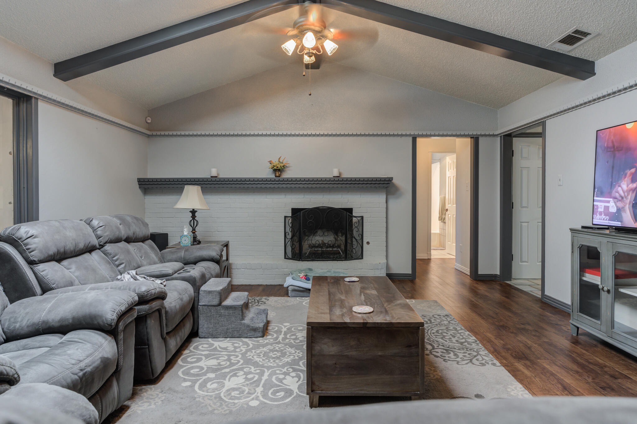 2608 74th Place Lubbock, TX 79423 - Photo 17 of 38 a living room with furniture and a fireplace