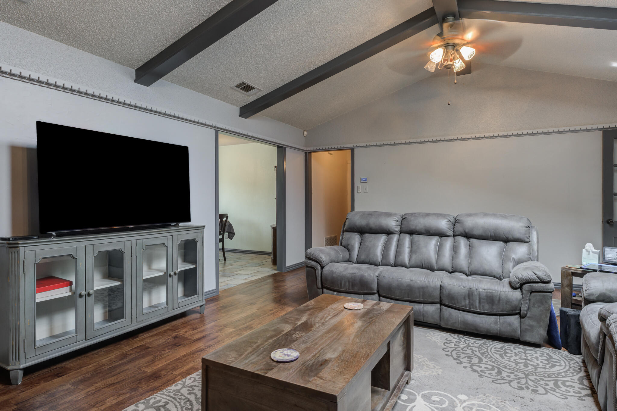 2608 74th Place Lubbock, TX 79423 - Photo 18 of 38 a living room with furniture and a flat screen tv