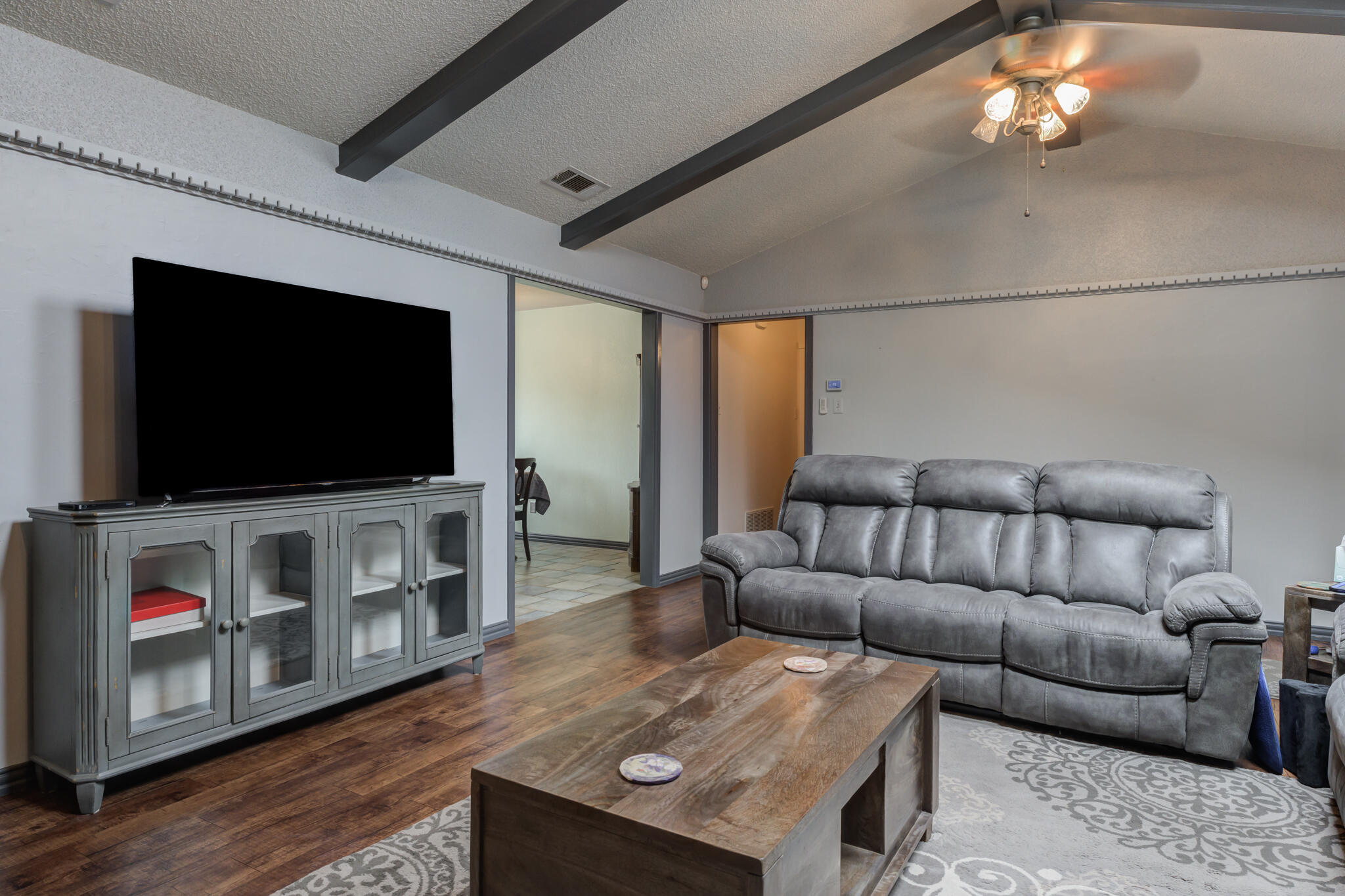 2608 74th Place Lubbock, TX 79423 - Photo 19 of 38 a living room with furniture and a flat screen tv