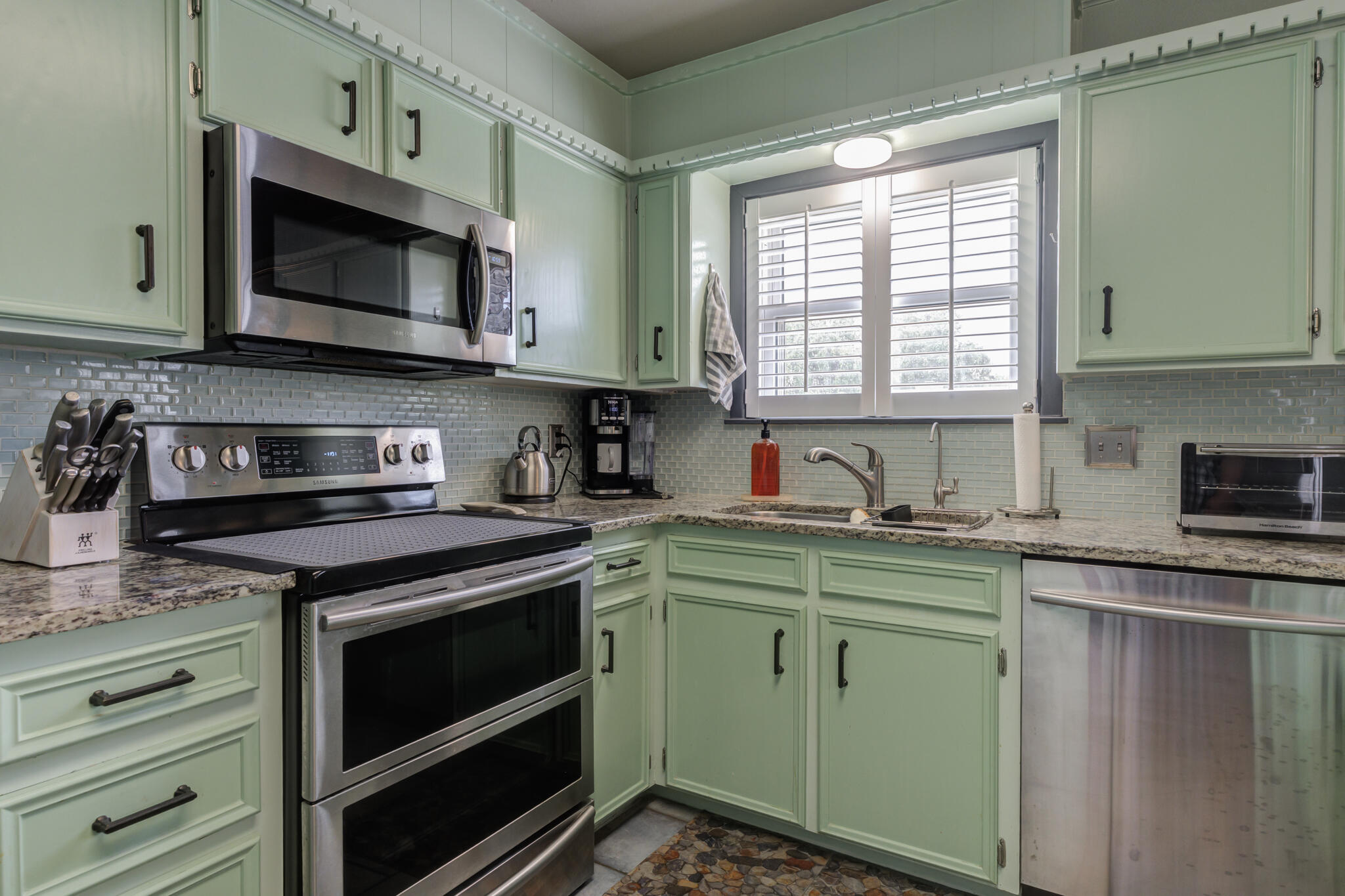 2608 74th Place Lubbock, TX 79423 - Photo 2 of 38 a kitchen with stainless steel appliances granite countertop a stove a microwave and a sink
