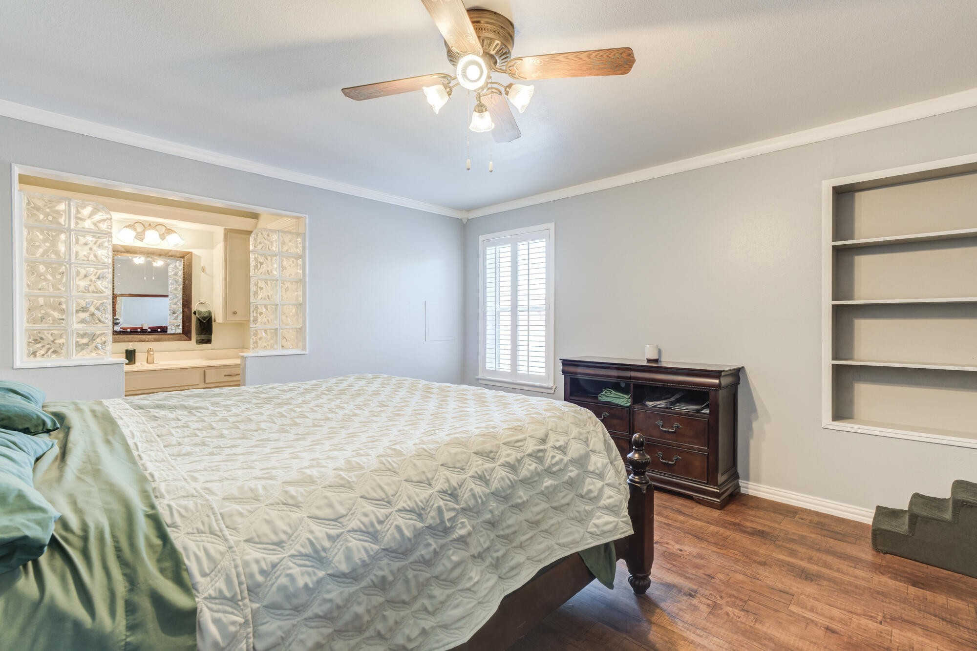 2608 74th Place Lubbock, TX 79423 - Photo 21 of 38 a bedroom with a bed dresser and a large window