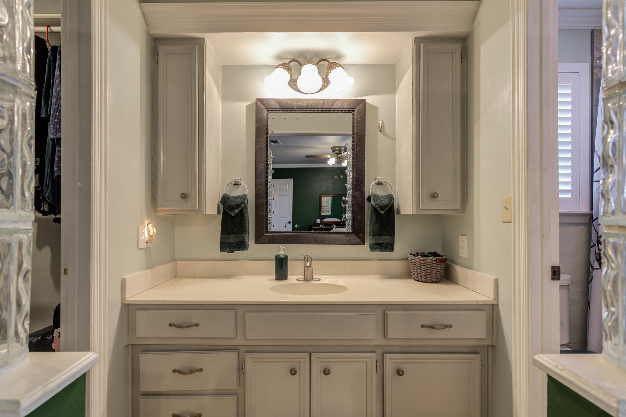 2608 74th Place Lubbock, TX 79423 - Photo 22 of 38 a bathroom with a sink and a mirror