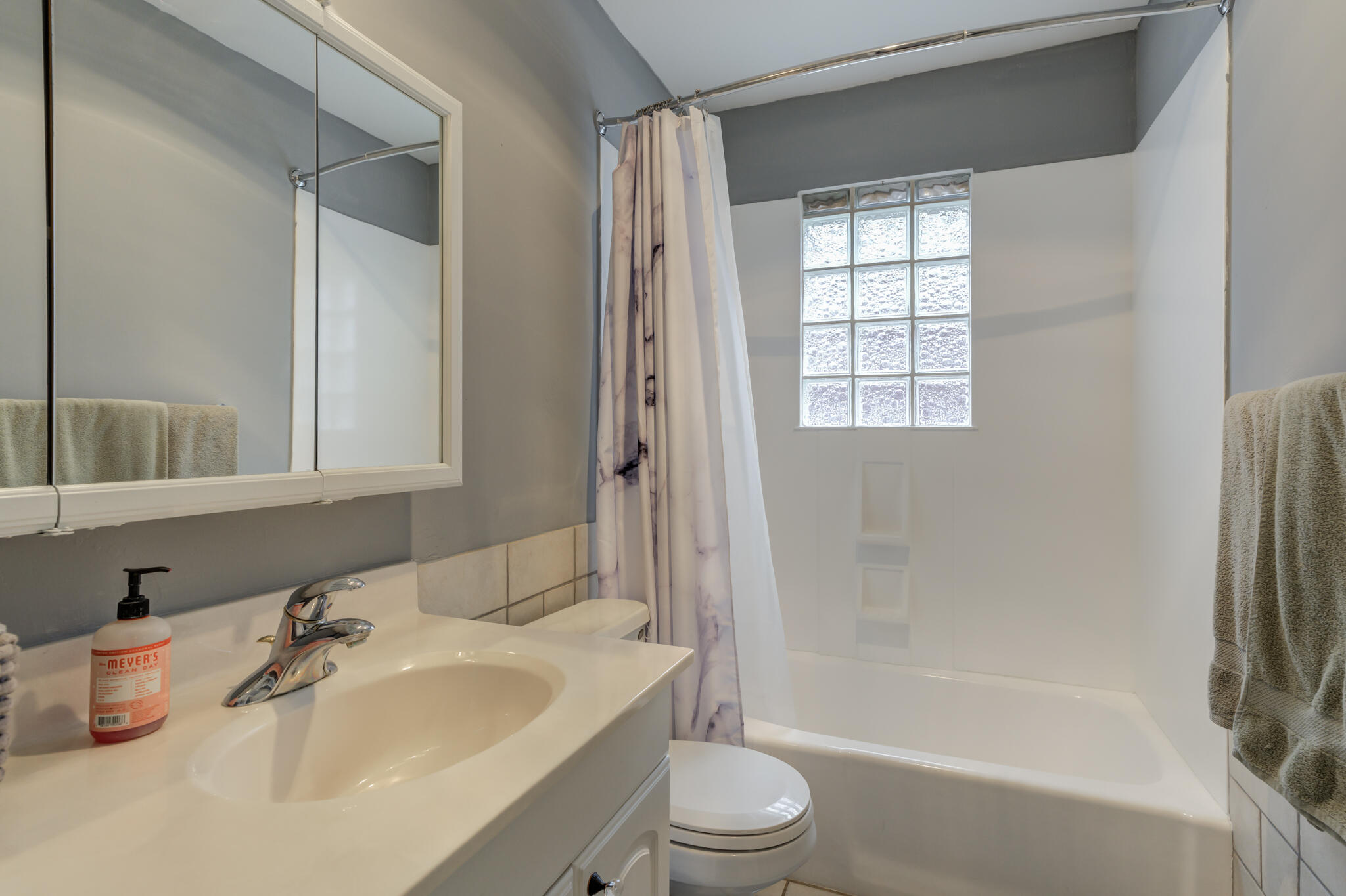 2608 74th Place Lubbock, TX 79423 - Photo 26 of 38 a bathroom with a bathtub shower sink vanity mirror and toilet