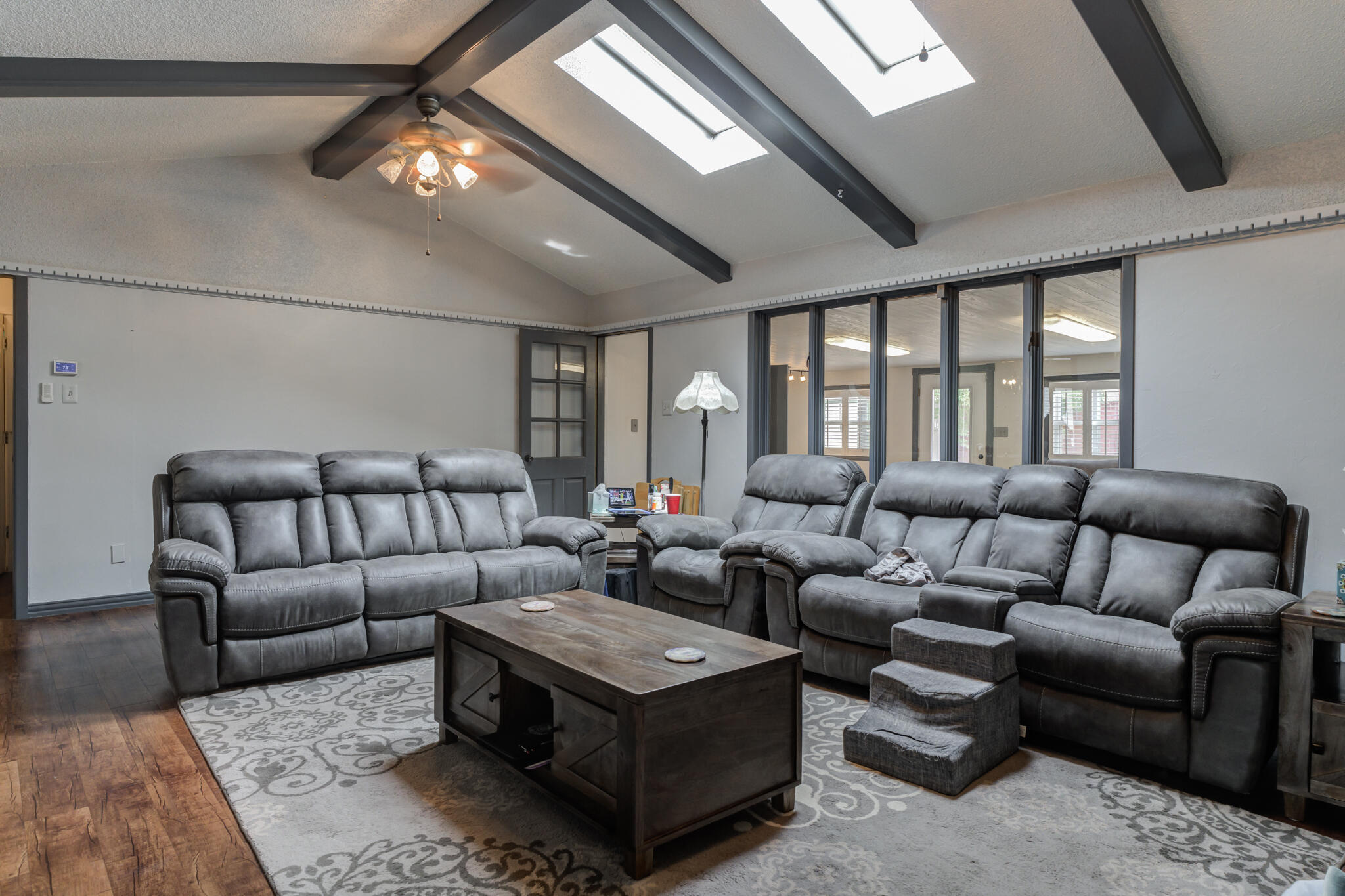2608 74th Place Lubbock, TX 79423 - Photo 3 of 38 a living room with furniture ceiling fan and a rug