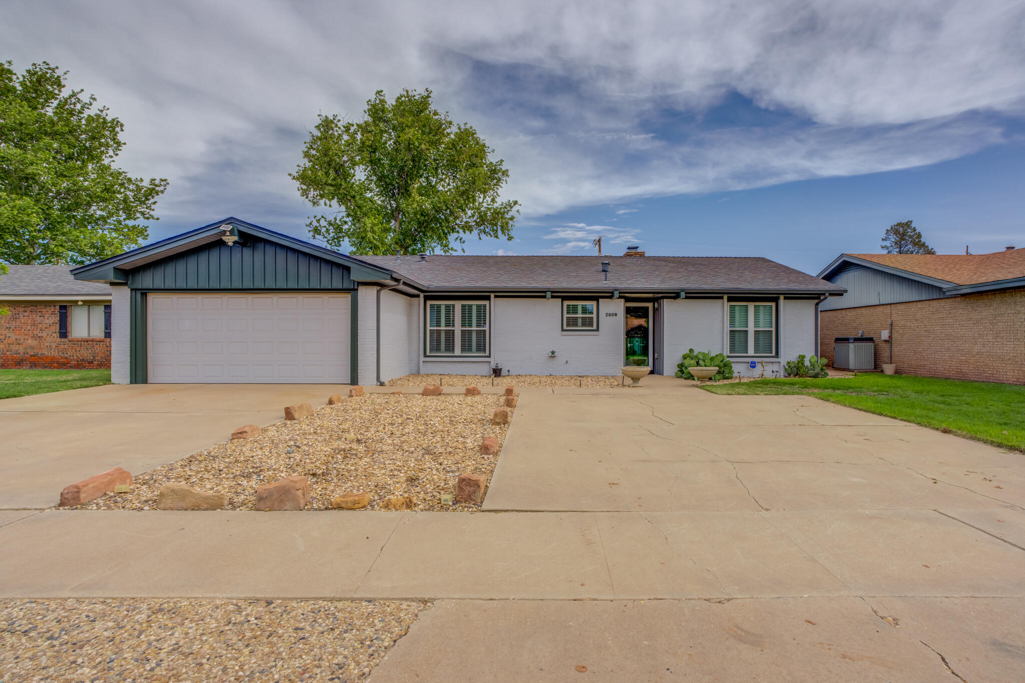 2608 74th Place Lubbock, TX 79423 - Photo 6 of 38 a front view of a house with a garden