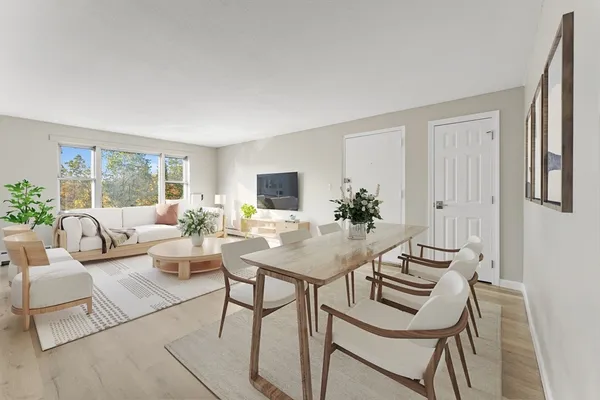 a living room with furniture a table and a potted plant