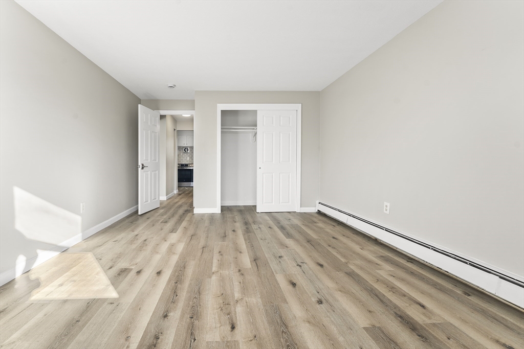 1 Colonial Drive, Unit C16 Andover, MA 01810 - Photo 13 of 32 a view of an empty room and wooden floor