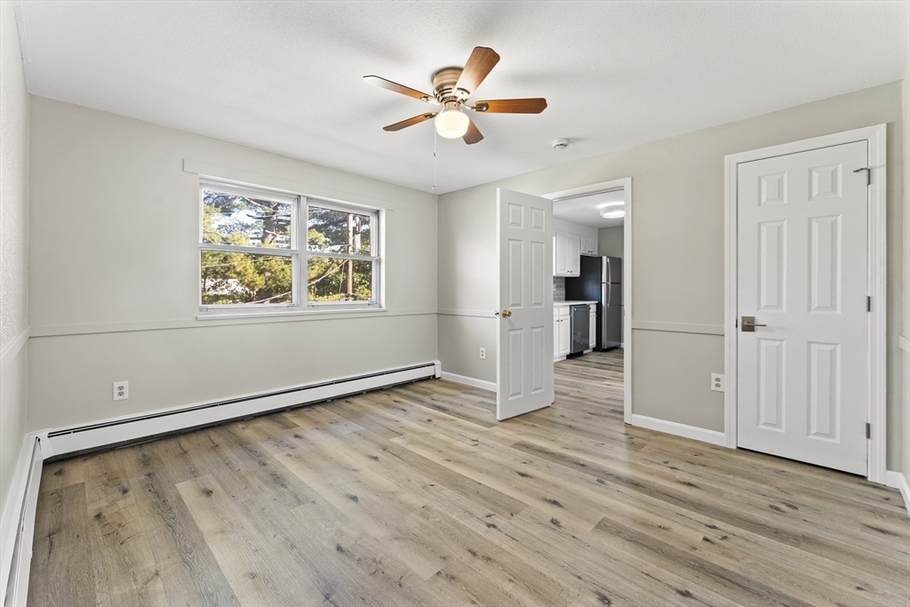 1 Colonial Drive, Unit C16 Andover, MA 01810 - Photo 19 of 32 wooden floor in an empty room with a window