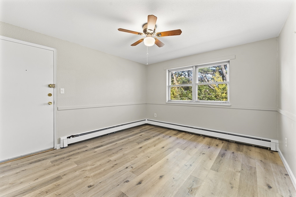 1 Colonial Drive, Unit C16 Andover, MA 01810 - Photo 21 of 32 wooden floor in an empty room with a window