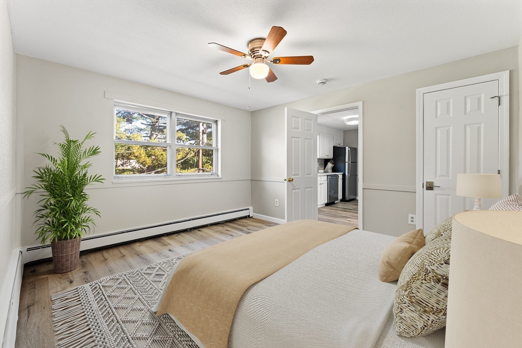 1 Colonial Drive, Unit C16 Andover, MA 01810 - Photo 3 of 32 a bedroom with a bed and a large window