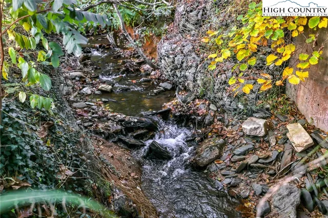 a view of deck with wooden floor and fence next to a yard