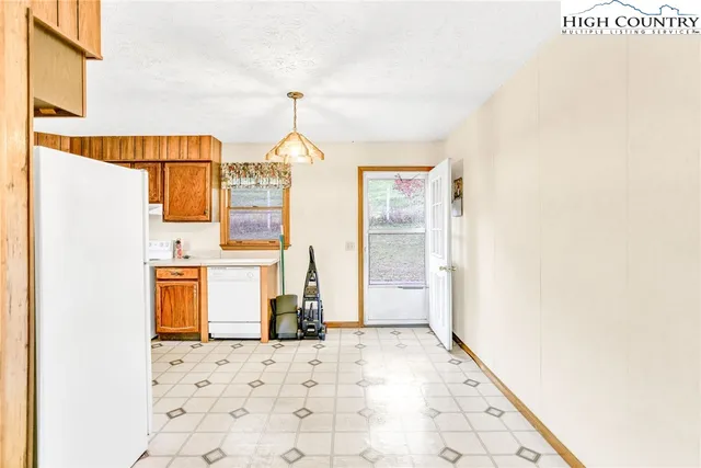 a kitchen with a sink a refrigerator and window