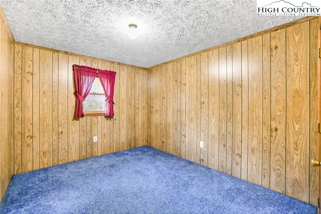 a view of an empty room with wooden walls