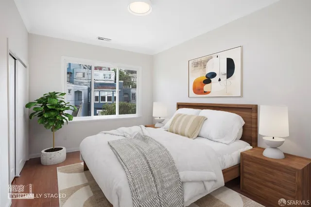 a bedroom with a bed and a painting on the wall