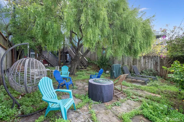 a front view of a house with a tree