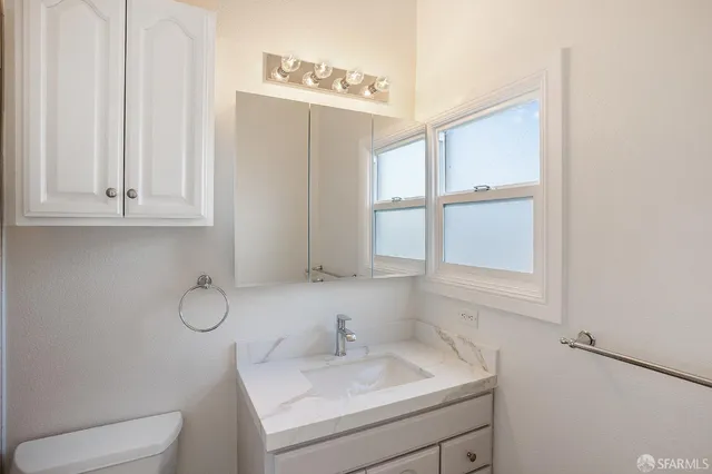 a bathroom with a sink toilet and vanity