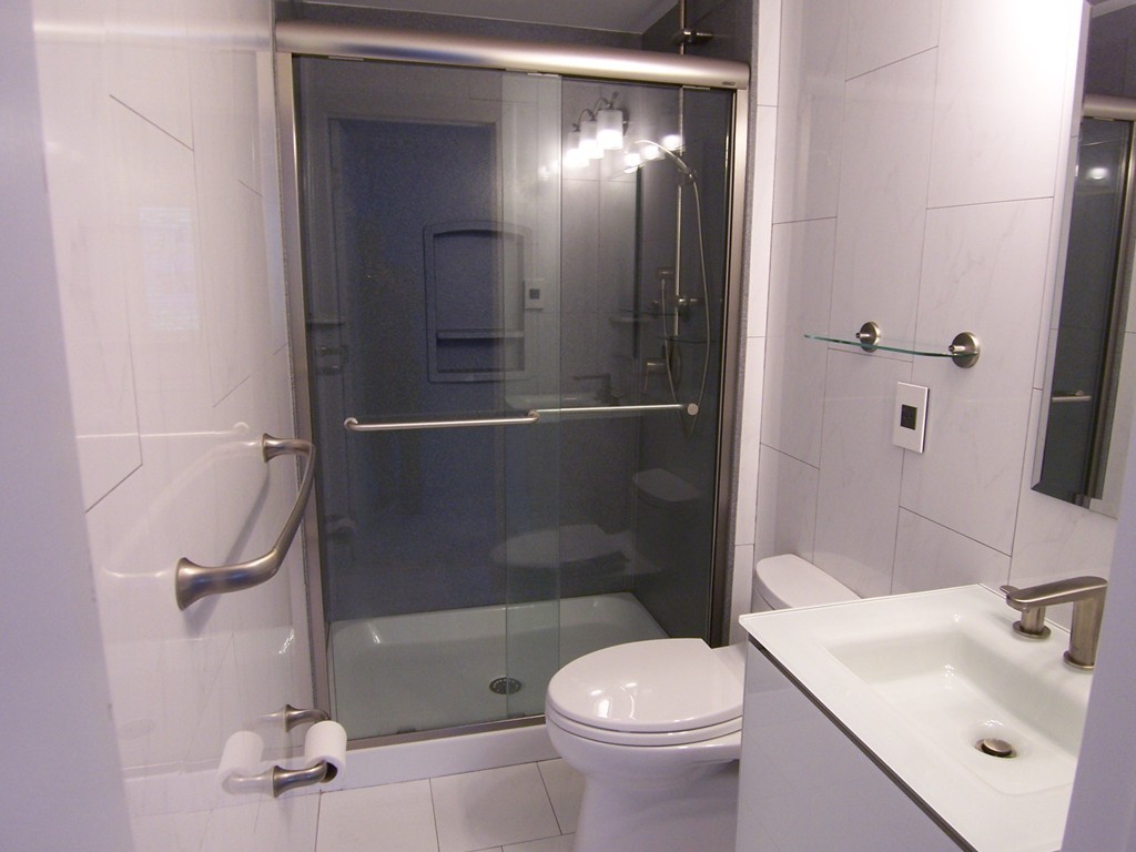 140 Lake Shore Road, Unit 1 Boston, MA 02135 - Photo 12 of 26 a bathroom with a sink a toilet and shower