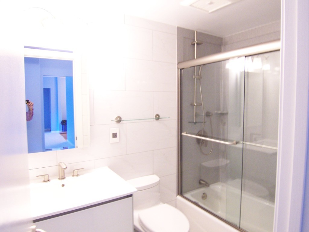 140 Lake Shore Road, Unit 1 Boston, MA 02135 - Photo 13 of 26 a bathroom with a sink toilet and shower
