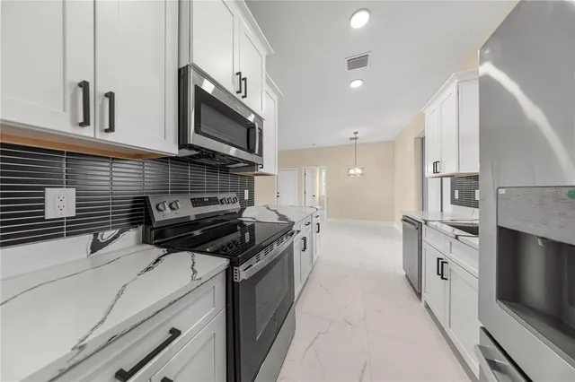 a kitchen with stainless steel appliances granite countertop a stove and a sink