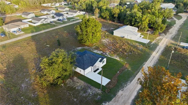an aerial view of a house with a yard