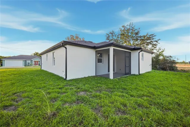 a house with green field in front of it