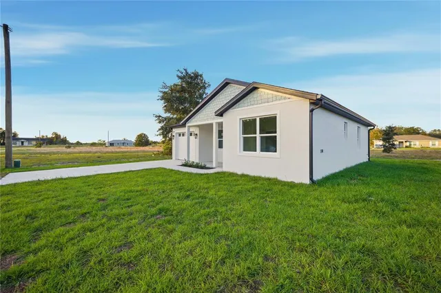a view of a backyard with plants and a big yard