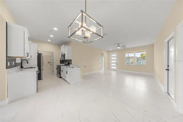 a view of a kitchen with a sink and a refrigerator
