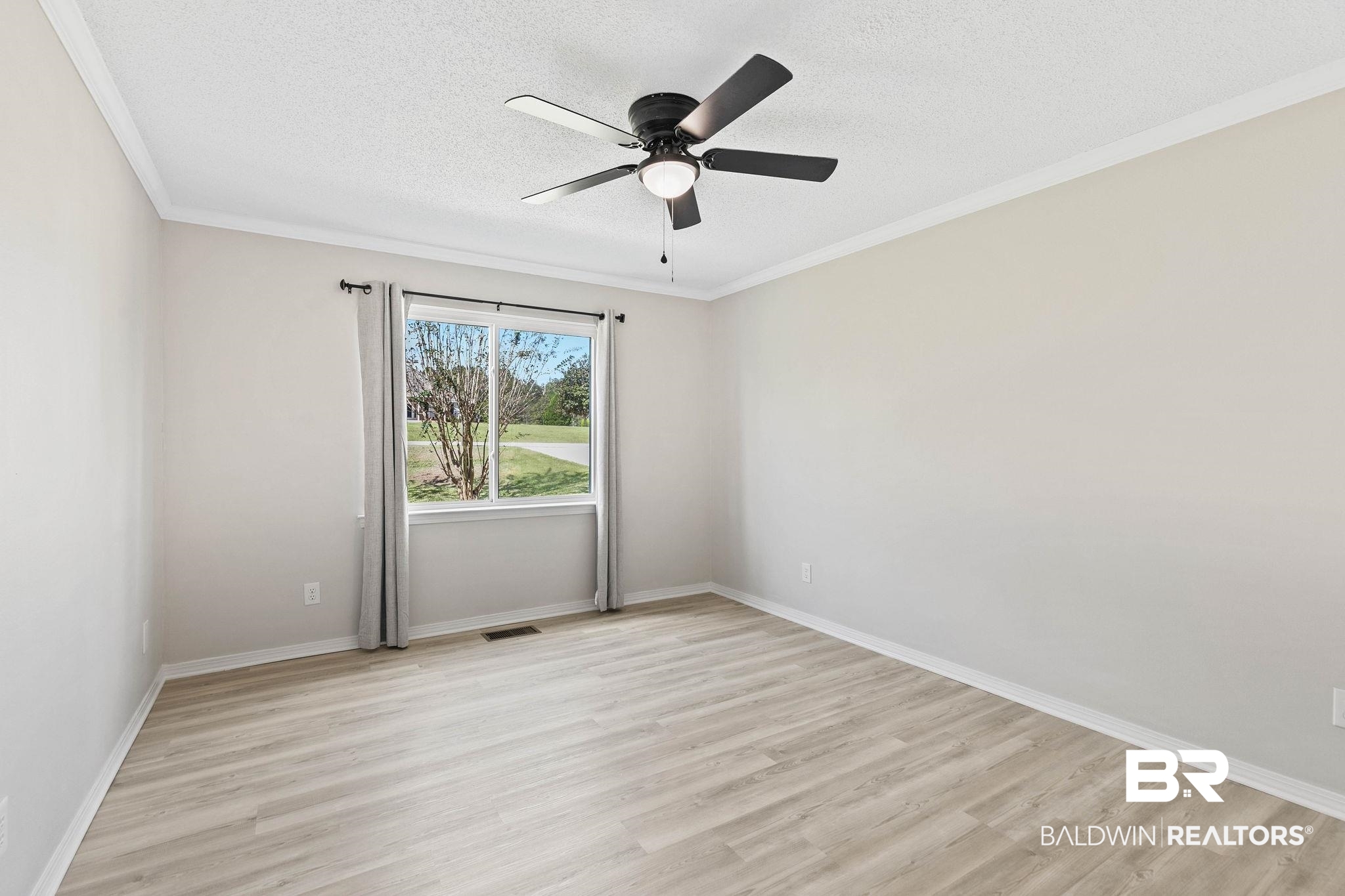 35650 Spring Road North Stapleton, AL 36578 - Photo 43 of 70 Empty room with a textured ceiling, light wood-type flooring, ornamental molding, and a ceiling fan